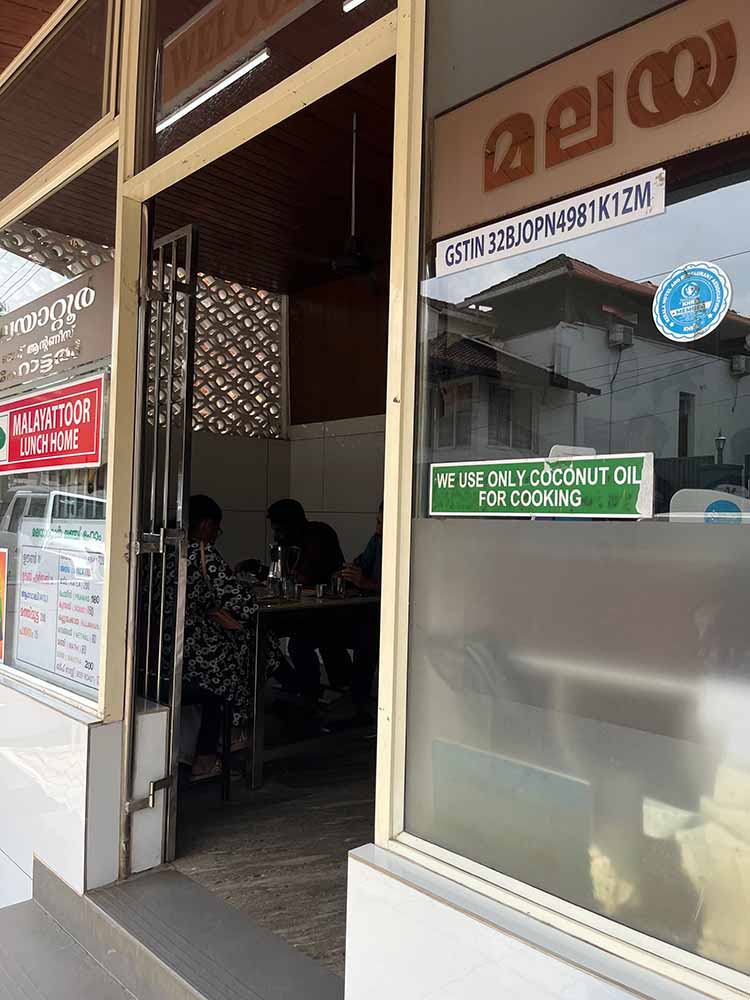 Welcome sign on the door into Malayattoor Hotel, a place to dine seed oil free with coconut oil. Welcome sign on the door into Malayattoor Hotel, a place to dine seed oil free with coconut oil.